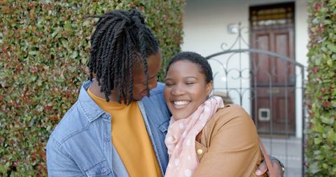 Joyful African American Couple Hugging Outdoors in Casual Style