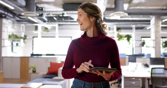 Smiling Businesswoman Holding Tablet in Modern Office Workspace - Download Free Stock Images Pikwizard.com