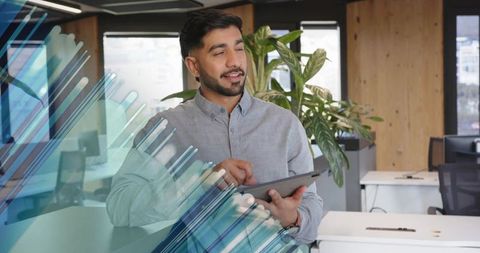 Modern professional man working on tablet in contemporary office
