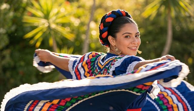 Twirling folklorico dancer wearing colorful braided ribbon crown and flowing skirt outdoors