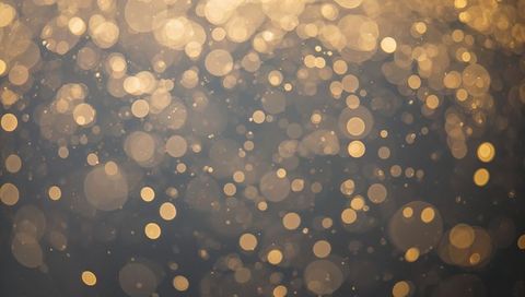 Glowing Golden Bokeh with Soft Halos and Floating Particles for Festive Elegance