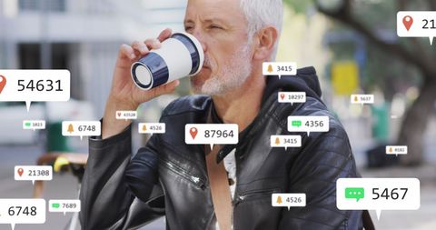 Senior man engaging with social media while drinking coffee