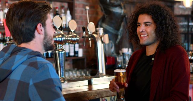 Two Young Men Enjoying Drinks at Bar Counter with Chatting and Laughing - Download Free Stock Images Pikwizard.com