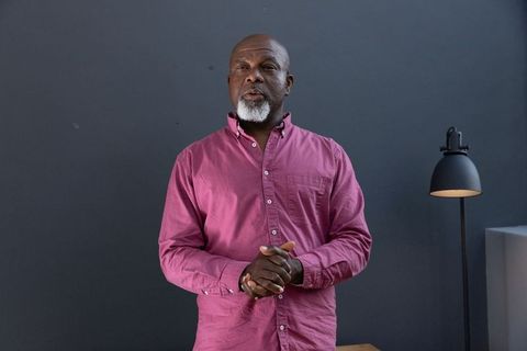 Senior Man Speaking in Modern Studio Environment