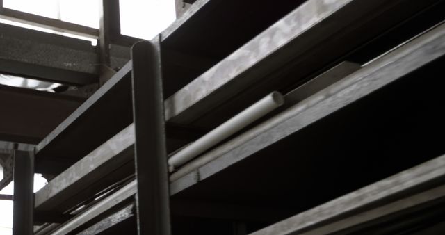 A close-up view of metal beams and pipes, part of a building's structure or an industrial setting. The focus on the architectural details emphasizes the complexity and design of modern construction.
