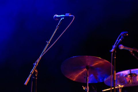 Live performance stage with drum set and microphone