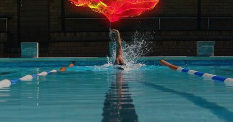 Backstroke Swimmer with Vibrant Red Light Trail