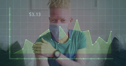 Masked man monitoring health analytics at home with green digital chart overlay