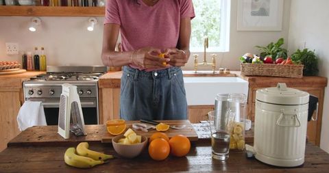 Woman preparing fresh fruit in cozy rustic kitchen
