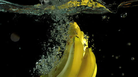 Bananas Splashing in Water Creating Bubbles