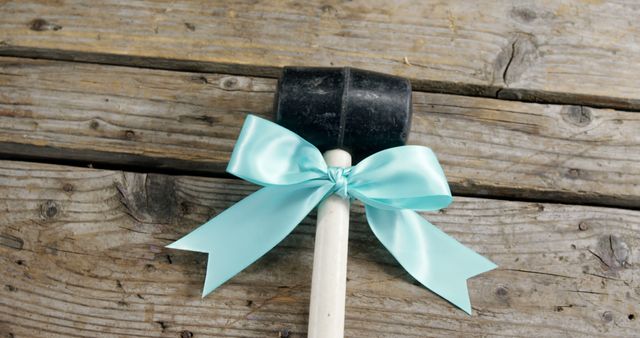 Hammer with Blue Bow on Wooden Background - Download Free Stock Images Pikwizard.com