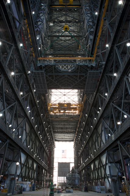 A heavy-lift crane lifts the first half of the B-level work platforms, B south, for NASA’s Space Launch System (SLS) rocket, high up from the transfer aisle floor of the Vehicle Assembly Building (VAB) at NASA’s Kennedy Space Center in Florida. Large Tandemloc bars have been attached to the platform to keep it level during lifting and installation. The B platform will be installed on the south side of High Bay 3. The B platforms are the ninth of 10 levels of work platforms that will surround and provide access to the SLS rocket and Orion spacecraft for Exploration Mission 1. The Ground Systems Development and Operations Program is overseeing upgrades and modifications to VAB High Bay 3, including installation of the new work platforms, to prepare for NASA’s Journey to Mars. 