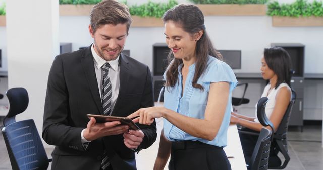 Business Colleagues Discussing Work on Tablet at Modern Office - Download Free Stock Images Pikwizard.com