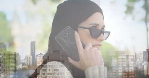 Modern Woman in Hijab Talking on Smartphone with Cityscape Background - Download Free Stock Images Pikwizard.com