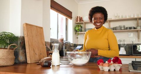 Happy Woman Preparing Ingredients in Modern Home Kitchen