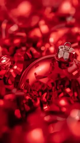 Shimmering Red Christmas Bauble Macro Vertical Video with Tinsel Reflections and Bokeh