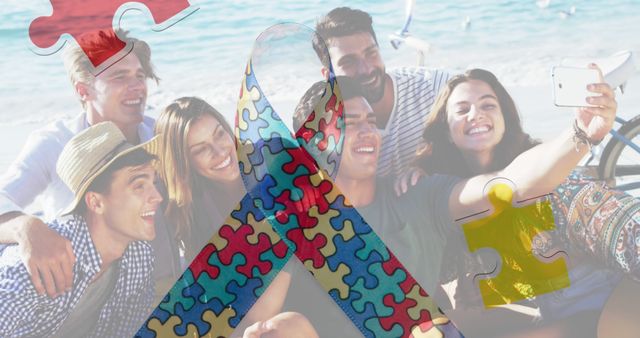 Group of friends smiling and taking a selfie at a sunny beach. Photo has bright colors and an overlay of autism awareness ribbon and puzzle pieces. Ideal for use in autism awareness promotions, supportive community activities, and social media campaigns.
