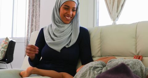 Mother and Daughter Bonding on Couch, Warm Living Room Scene