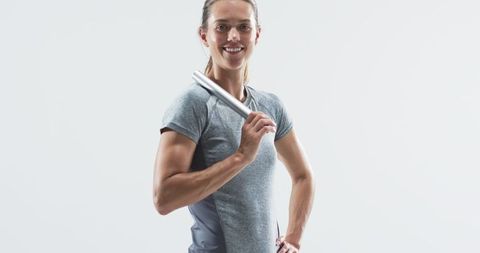 Confident Athletic Woman Holding Relay Baton for Race