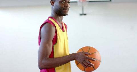 Focused Athlete Holding Basketball Indoor Ready for Game