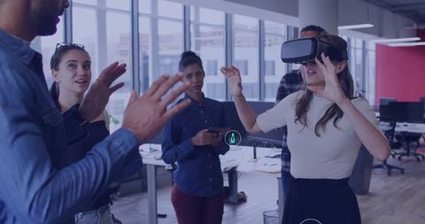 Team Collaborating in Open Office Wearing VR Headsets