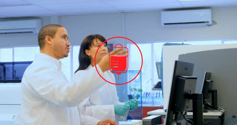 Scientists Analyzing Data with Digital Overlay in Laboratory