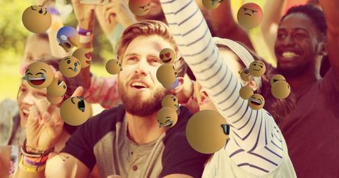 Friends Enjoying Outdoor Fun with Floating Emojis