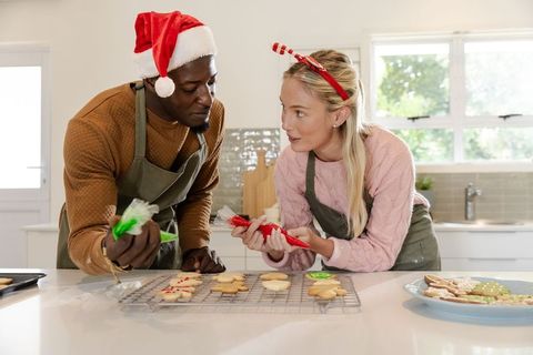 Diverse Couple Decorating Holiday Cookies in Festive Kitchen