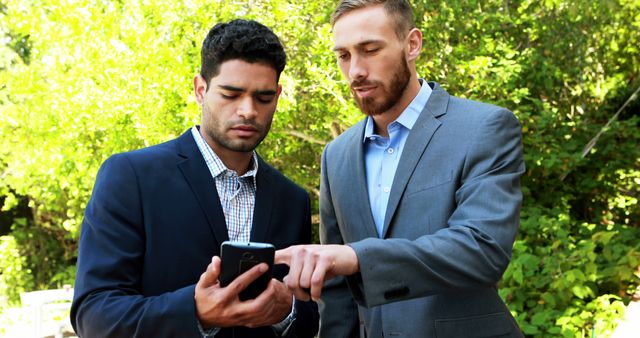 Businessmen Collaborating Outdoors Using Smartphone - Download Free Stock Photos Pikwizard.com