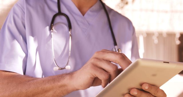 Doctor Using Digital Tablet with Stethoscope in Medical Facility - Download Free Stock Images Pikwizard.com