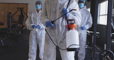 Disinfection crew sanitizing gym for health and safety