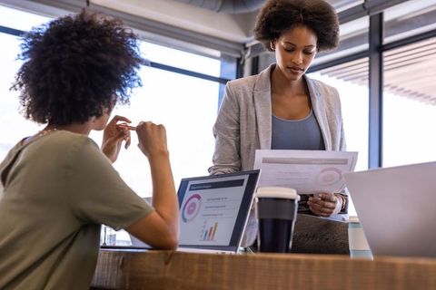 Collaboration Among Diverse Female Coworkers in Modern Office