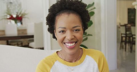 Smiling African American Woman Relaxing at Home on Couch