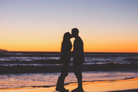 Silhouette Couple Kissing at Romantic Beach Sunset