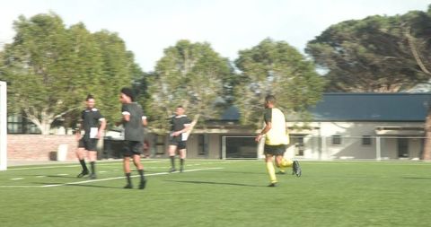 Soccer Players Engaging in Practice Under Sunny Skies
