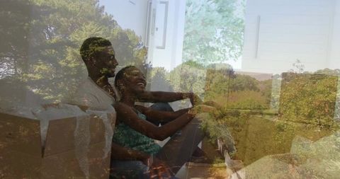 Joyful Couple Relaxing on Floor with Moving Boxes in New Home