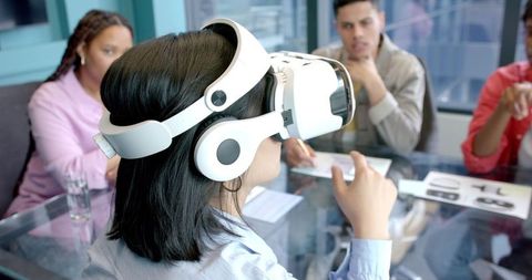 Woman using vr headset in office meeting