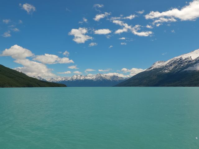 Serene Mountain Lake with Snow-Capped Peaks and Blue Sky - Download Free Stock Photos Pikwizard.com