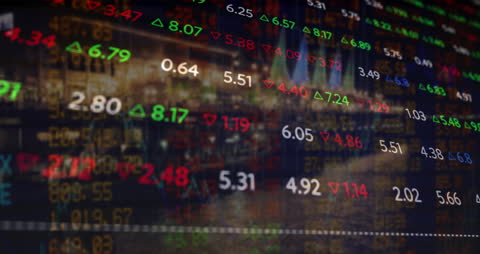 Dynamic Stock Market Data Over Cityscape at Night