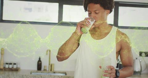 African american man drinking smoothie with dna overlay