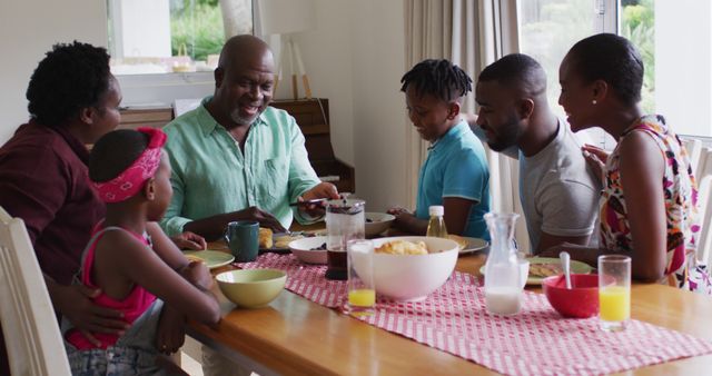 Family Enjoying Breakfast Conversation at Dining Table - Download Free Stock Images Pikwizard.com