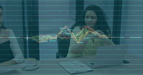 Businesswoman Gesturing Over Virtual Data Visualization During Team Analytics Meeting