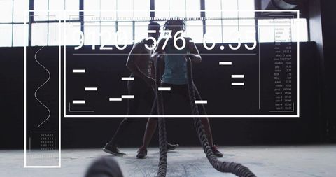 Athletes Training with Battle Ropes in Modern Gym with Digital Overlay