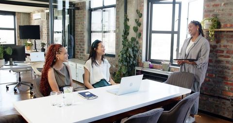 Diverse Female Team Meeting in Modern Office Setting