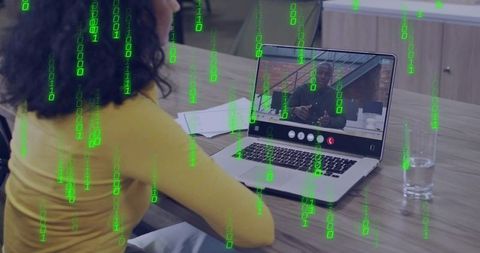 Woman Videoconferencing on Laptop with Green Binary Code Overlay for Cybersecurity Concept