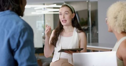 Woman Using Tablet for Discussion in Modern Office