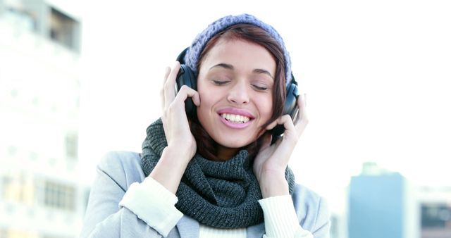 Smiling Woman Listening to Music Outdoors on a Winter Day - Download Free Stock Images Pikwizard.com