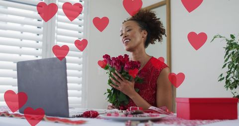 Joyful woman using laptop surrounded by hearts on valentine's day