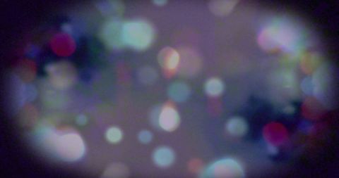 Abstract Glowing Colored Light Bokeh on Dark Background