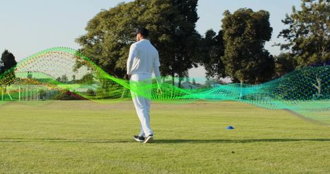 Walking cricket athlete in white uniform with flowing green digital wave overlay on field